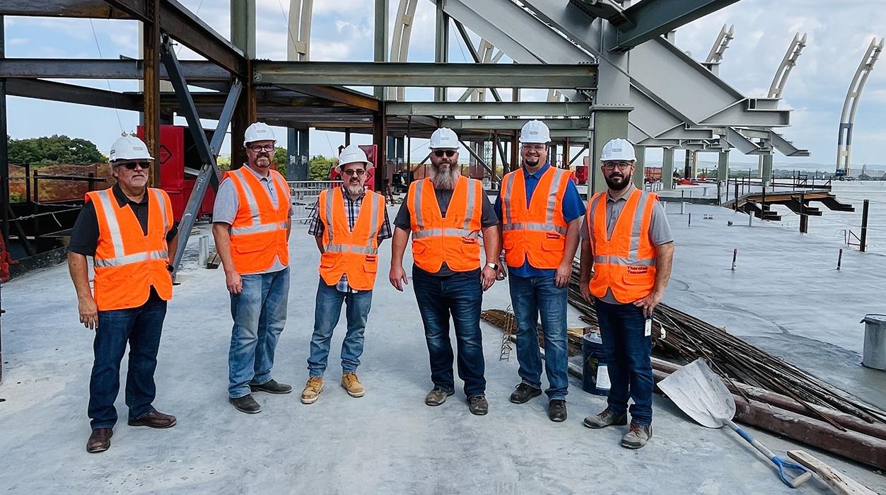 From left, Paul Robinson, Heath Morgan, Mike White, Greg Johnston, David Laub and Robert Brashears at the The David Booth Kansas Memorial Stadium topping out ceremony in Lawrence, Kansas.