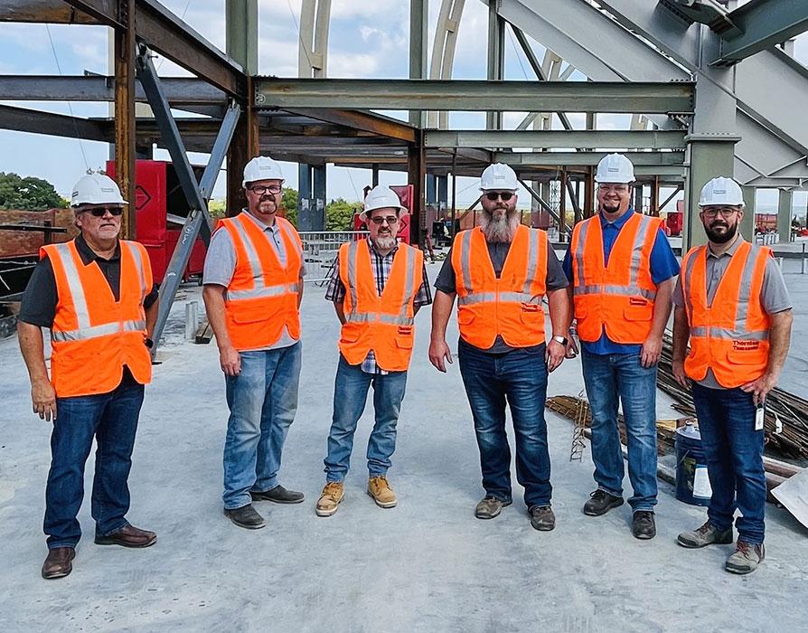 From left, Paul Robinson, Heath Morgan, Mike White, Greg Johnston, David Laub and Robert Brashears at the The David Booth Kansas Memorial Stadium topping out ceremony in Lawrence, Kansas.