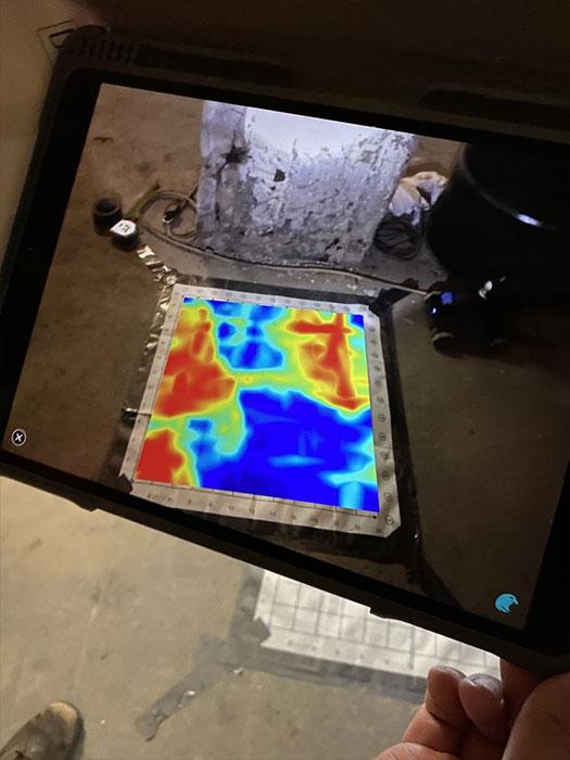 Augmented reality feature of a GPR device shows voids under the slab on grade.